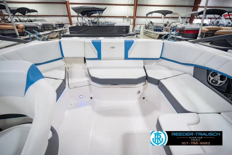 Slide: The Image of 2015 Regal 2000 ESX Bowrider interior with white and blue seating in showroom. - 21