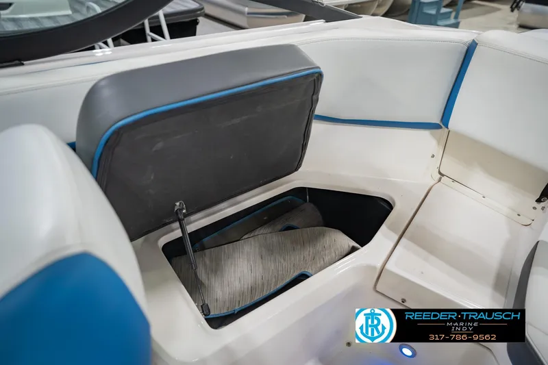 Slide: The Image of 2015 Regal 2000 ESX Bowrider interior storage compartment with blue accents. - 23