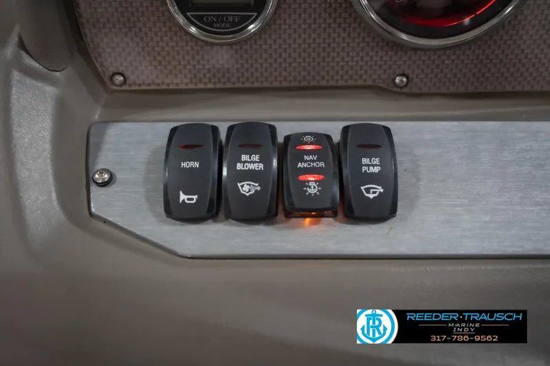Slide: The Image of Control panel of a 2015 Regal 2000 ESX Bowrider with labeled switches. - 32