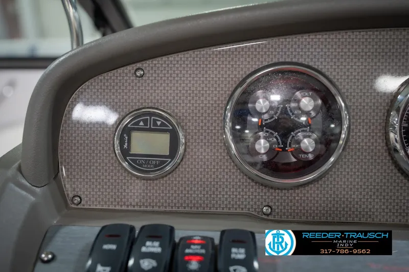 Slide: The Image of Dashboard of a 2015 Regal 2000 ESX Bowrider with gauges and controls. - 33