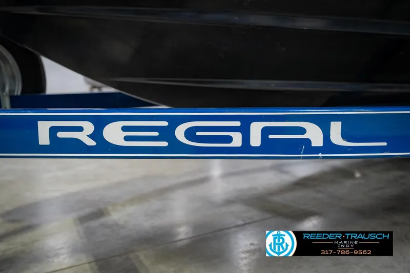Slide: The Image of 2015 Regal 2000 ESX Bowrider boat trailer with logo, displayed indoors. - 54