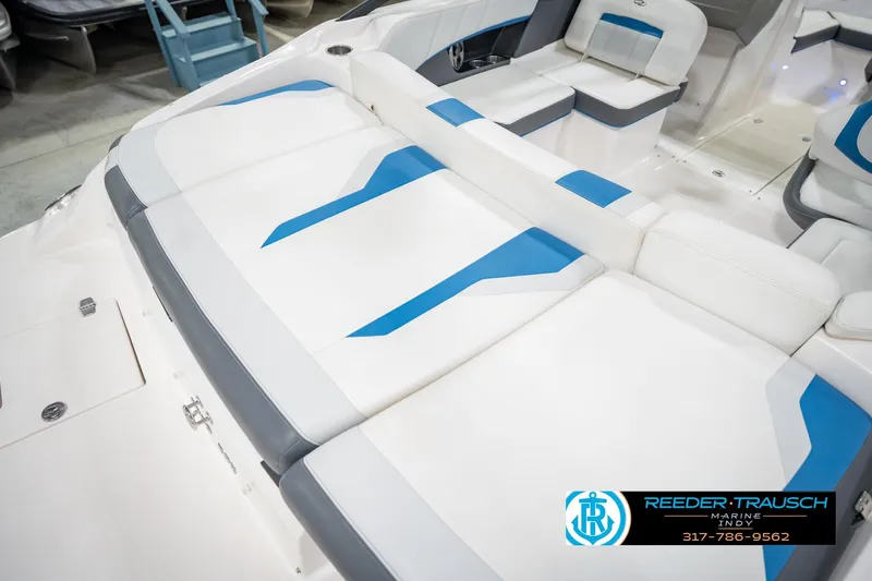Slide: The Image of 2015 Regal 2000 ESX Bowrider interior with white and blue seating, showcased by Reeder Trausch Marine. - 56
