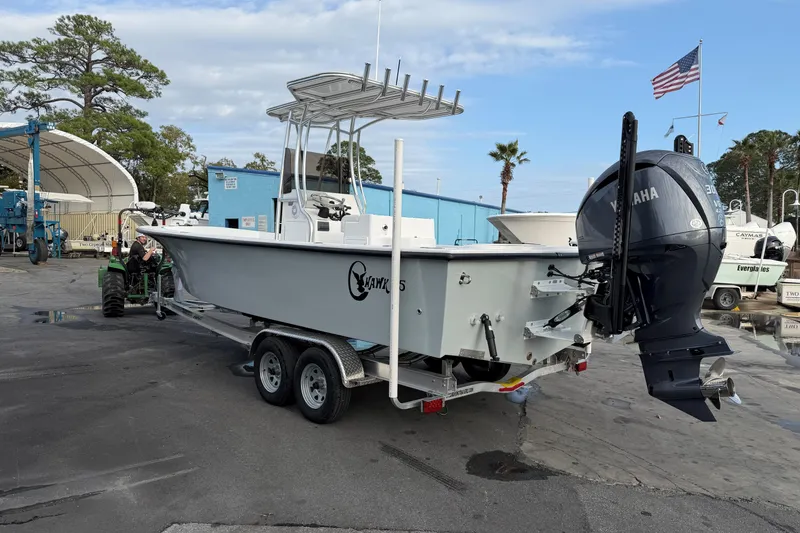 Slide: The Image of 2026 C-Hawk 25 Center Console boat on trailer with Yamaha engine in marina setting. - 2