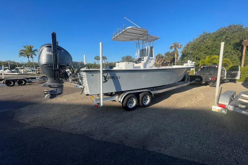Slide: The Image of 2026 C-Hawk 25 Center Console boat on trailer, parked outdoors under clear blue sky. - 3