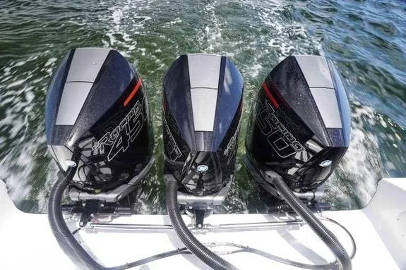 Slide: The Image of Triple outboard motors on 2023 Fountain 38 Tournament Edition boat in action. - 11