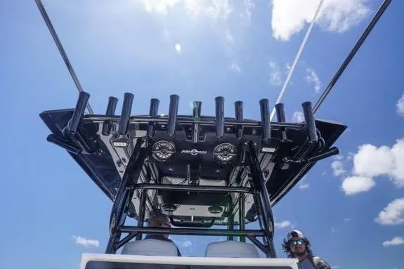 Slide: The Image of 2023 Fountain 38 Tournament Edition boat with rod holders, viewed from below against a blue sky. - 13