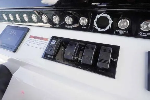 Slide: The Image of Control panel of 2023 Fountain 38 Tournament Edition boat with switches and display. - 29