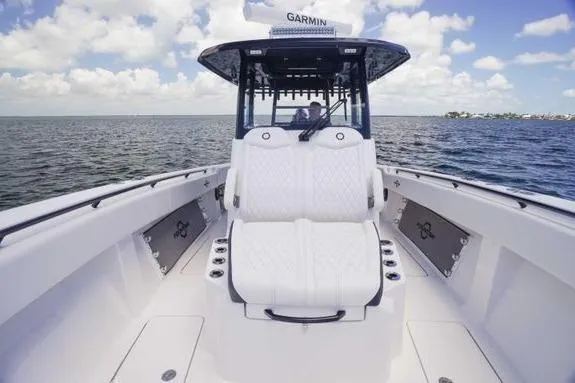 Slide: The Image of 2023 Fountain 38 Tournament Edition boat on open water, featuring luxurious seating and Garmin equipment. - 30