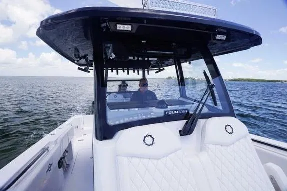 Slide: The Image of 2023 Fountain 38 Tournament Edition boat cruising on open water under a clear sky. - 40