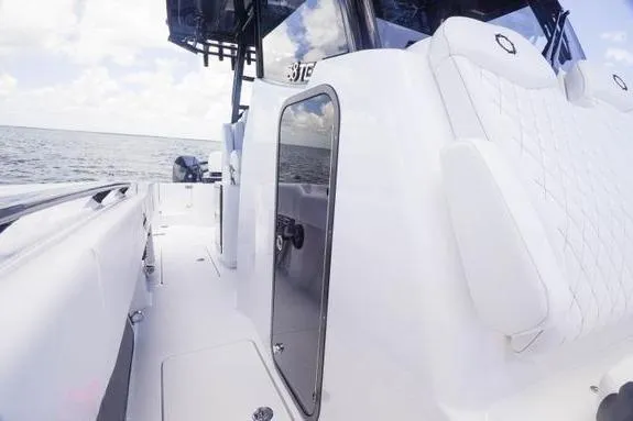 Slide: The Image of 2023 Fountain 38 Tournament Edition boat, sleek white deck, ocean backdrop, modern design. - 44