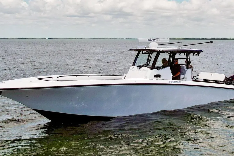 Slide: The Image of 2023 Fountain 38 Tournament Edition boat cruising on open water under cloudy sky. - 5