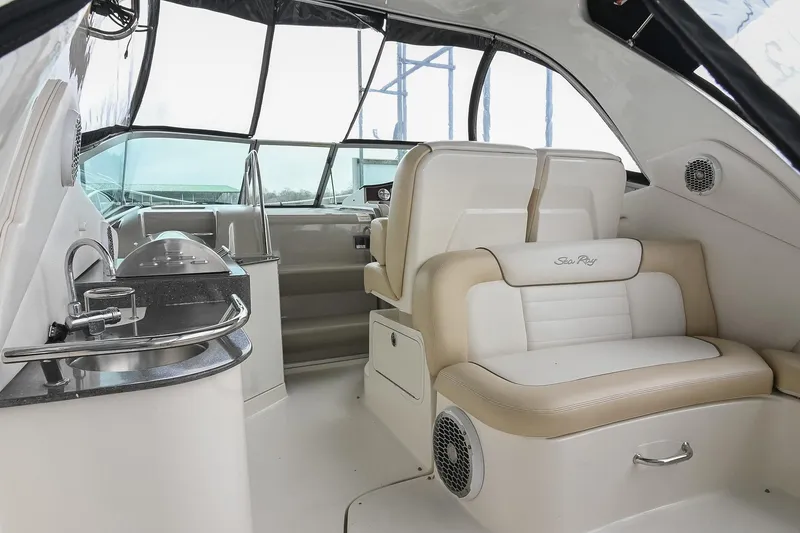 Slide: The Image of Interior of 2012 Sea Ray Sundancer 330 yacht with helm, seating, and kitchenette. - 10