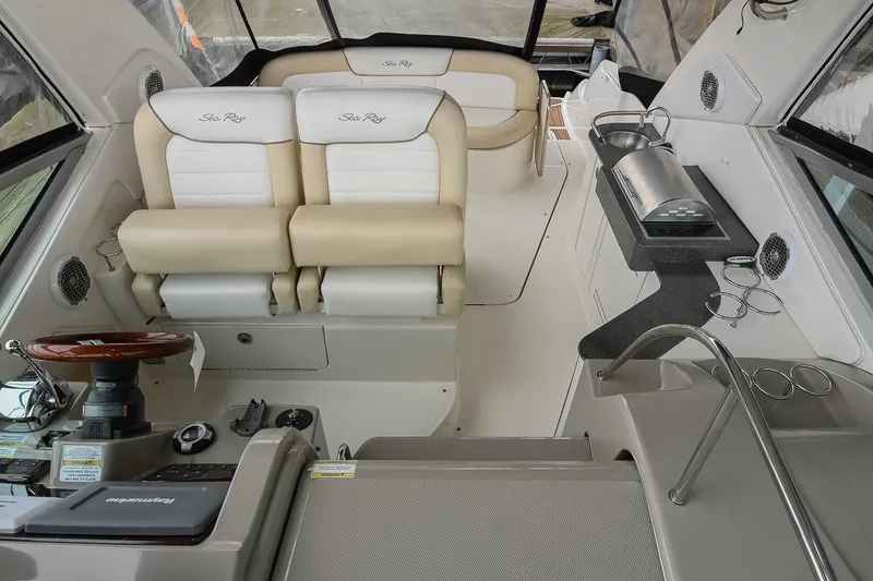 Slide: The Image of 2012 Sea Ray Sundancer 330 boat interior with beige and white seating. - 11
