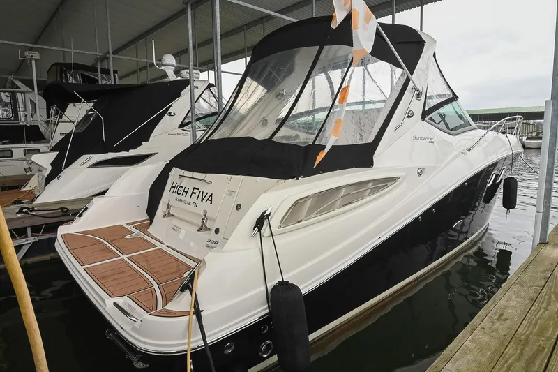 Slide: The Image of 2012 Sea Ray Sundancer 330 docked, featuring sleek design and modern amenities. - 2