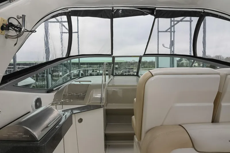 Slide: The Image of Interior view of 2012 Sea Ray Sundancer 330 yacht cockpit with steering wheel and controls. - 21