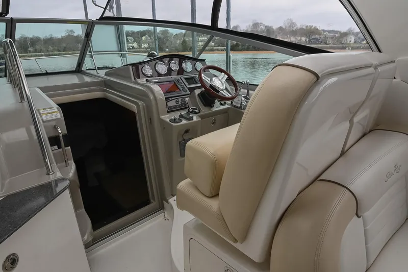 Slide: The Image of Cockpit of 2012 Sea Ray Sundancer 330 with steering wheel and navigation controls. - 22