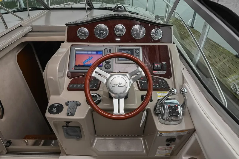 Slide: The Image of Control panel of a 2012 Sea Ray Sundancer 330 boat with dual throttle levers. - 24