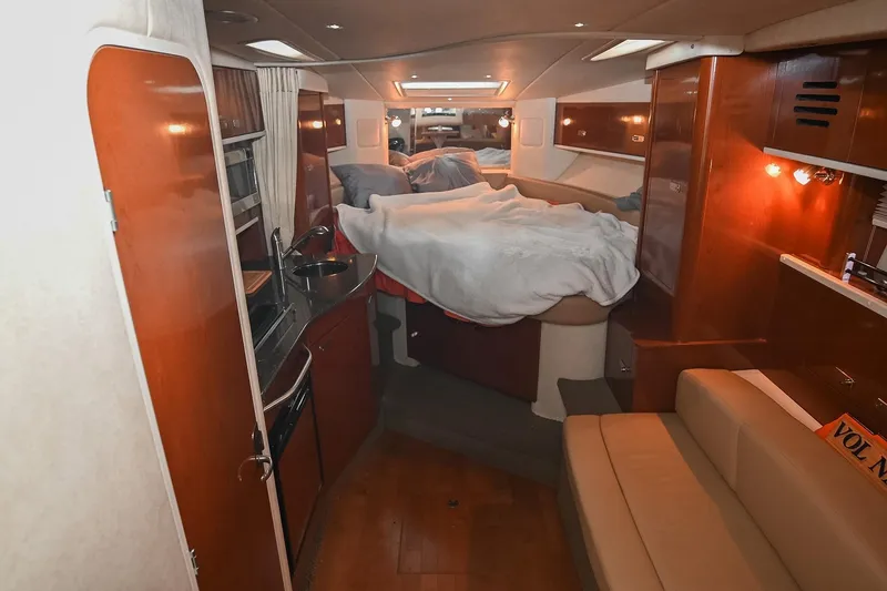Slide: The Image of Interior of 2012 Sea Ray Sundancer 330 with beige leather seating and wooden flooring. - 30