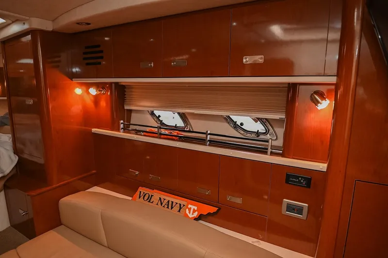 Slide: The Image of Interior of 2012 Sea Ray Sundancer 330 with beige seating and wooden flooring. - 32