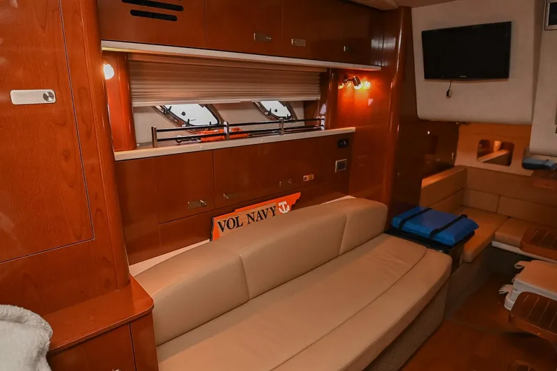 Slide: The Image of 2012 Sea Ray Sundancer 330 interior with kitchenette, microwave, and cozy sleeping area. - 34