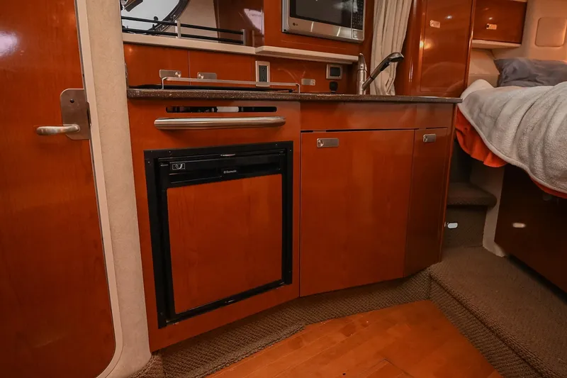 Slide: The Image of 2012 Sea Ray Sundancer 330 yacht kitchen with modern appliances and sleek countertops. - 36