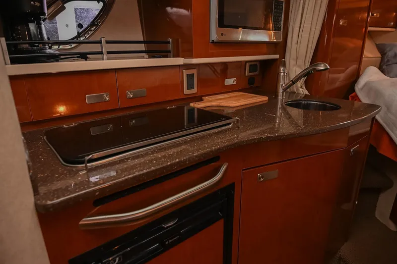 Slide: The Image of 2012 Sea Ray Sundancer 330 kitchen with stove and countertop. - 37