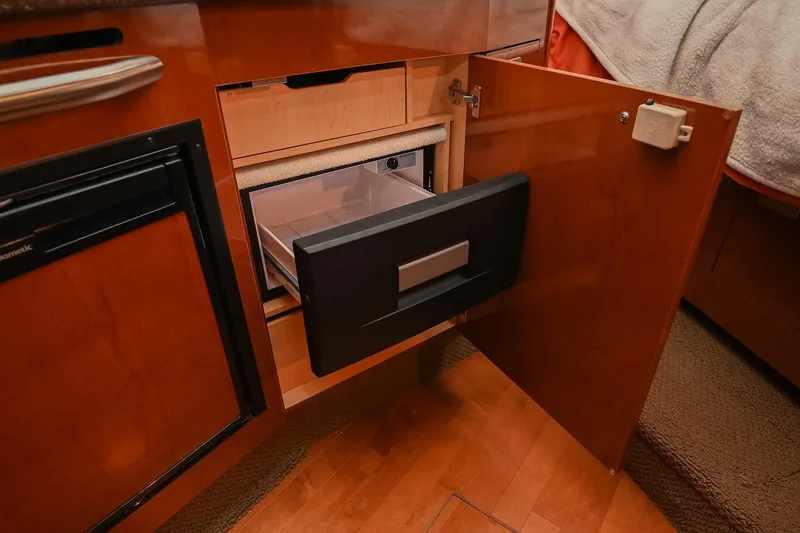 Slide: The Image of Luxurious 2012 Sea Ray Sundancer 330 cabin interior with bed and kitchenette. - 39