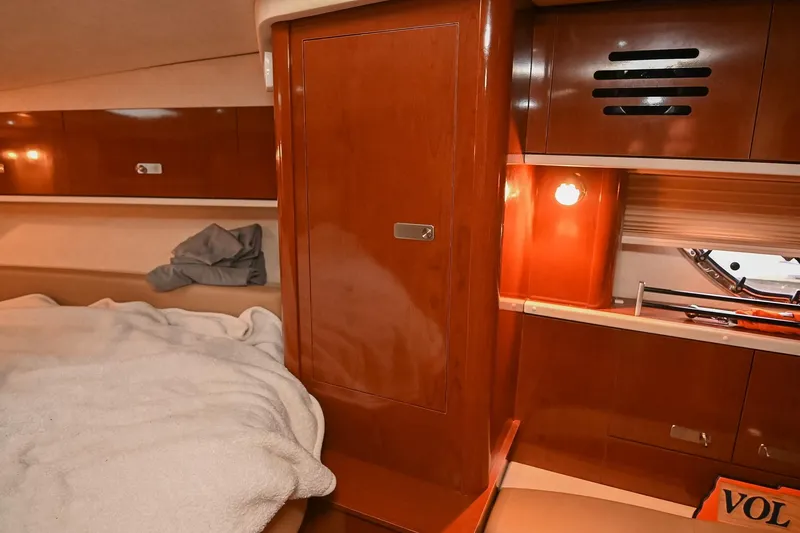 Slide: The Image of Interior of 2012 Sea Ray Sundancer 330 yacht with wooden steps and beige seating. - 44