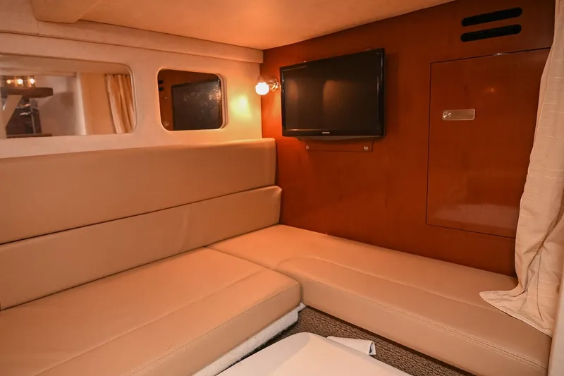 Slide: The Image of 2012 Sea Ray Sundancer 330 helm with gauges and navigation controls, docked at marina. - 49