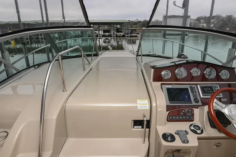 Slide: The Image of 2012 Sea Ray Sundancer 330 yacht docked under a covered marina. - 50