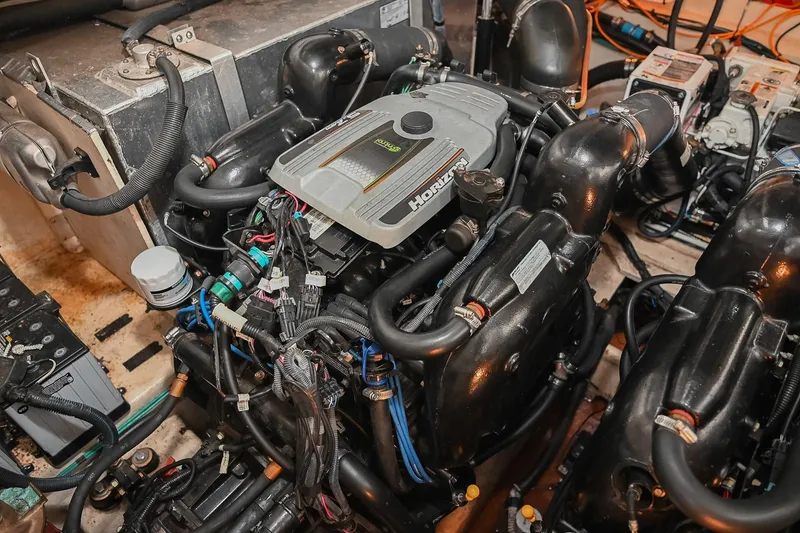 Slide: The Image of Engine compartment of a 2012 Sea Ray Sundancer 330 boat, showcasing detailed components. - 55