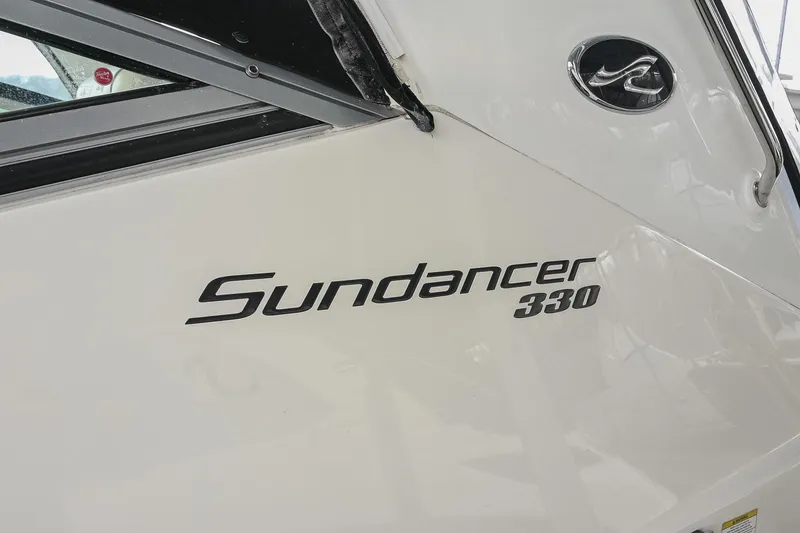 Slide: The Image of 2012 Sea Ray Sundancer 330 docked, featuring teak swim platform and black canvas cover. - 6