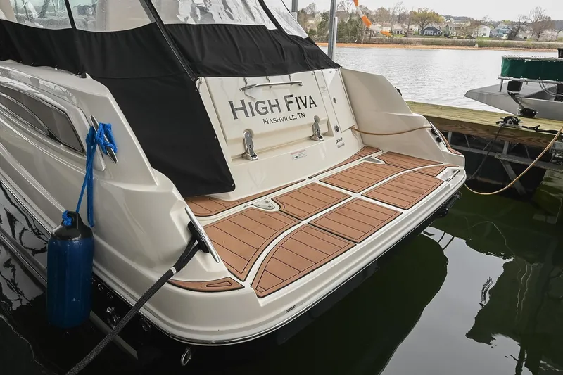 Slide: The Image of 2012 Sea Ray Sundancer 330 boat seat with beige and white upholstery. - 7