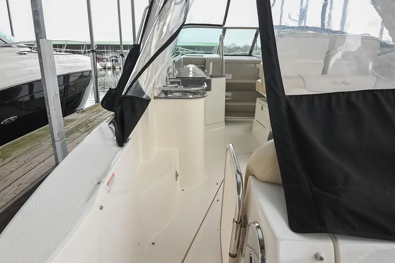 Slide: The Image of Interior of 2012 Sea Ray Sundancer 330 yacht with seating and kitchenette area. - 9