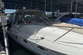 The Image of 2003 Doral 310se boat docked in a covered marina. - 1