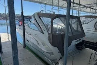 Slide: The Image of 2003 Doral 310se boat docked under a covered marina. - 3