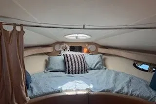 Slide: The Image of Cozy cabin interior of 2003 Doral 310se boat with bed and porthole. - 5