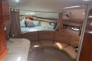 Slide: The Image of Interior of 2003 Doral 310se boat with cozy seating and bed area. - 6