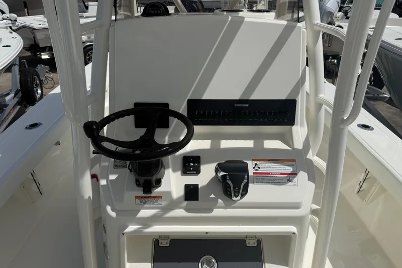 Slide: The Image of 2026 Pathfinder 2600 TRS boat console with steering wheel and controls. - 12