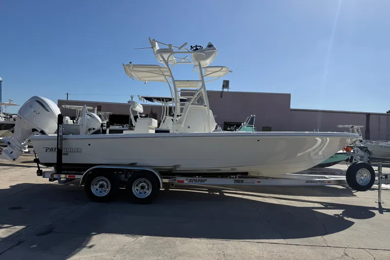 Slide: The Image of 2026 Pathfinder 2600 TRS boat on trailer in sunny outdoor setting. - 2