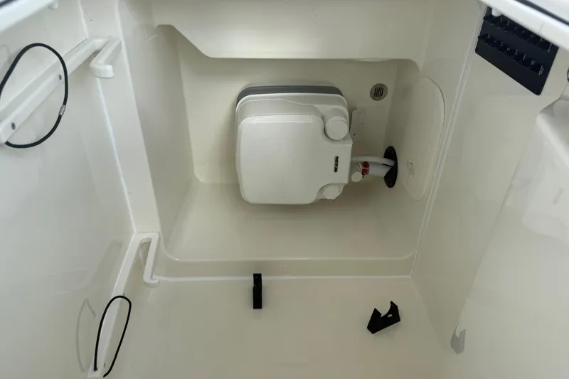 Slide: The Image of 2026 Pathfinder 2600 TRS boat interior compartment with equipment and wiring. - 7