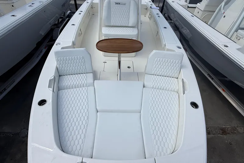 Slide: The Image of 2026 Pathfinder 2600 TRS boat interior with white seating and wooden table. - 8