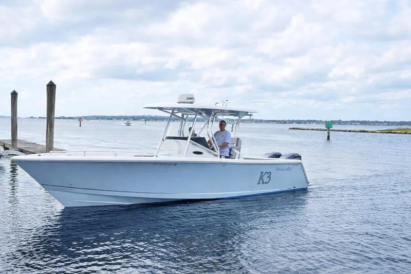 The Image of 2020 Release 301 RX boat cruising on calm waters under a cloudy sky. - 0
