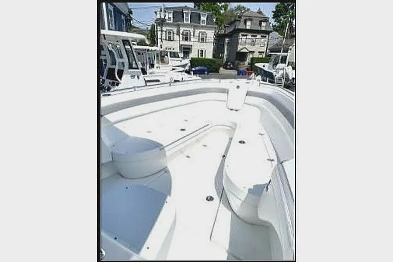 Slide: The Image of 2020 Release 301 RX boat with spacious deck in harbor. - 7