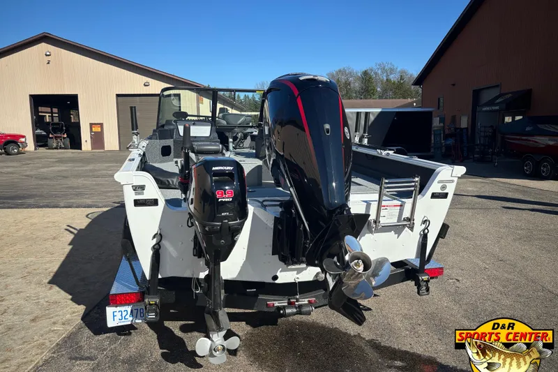 Slide: The Image of 2026 Lund 1800 Explorer Sport boat with dual Mercury outboard motors at dealership. - 2