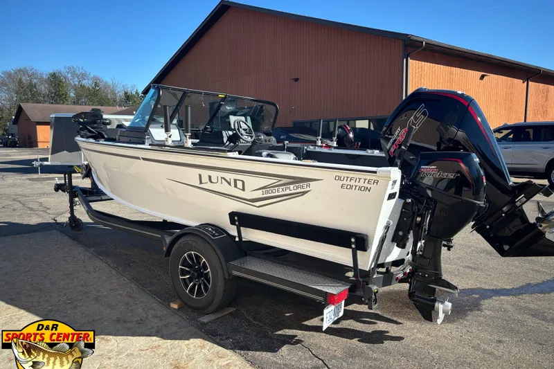 Slide: The Image of 2026 Lund 1800 Explorer Sport boat with Mercury engine, parked outdoors at D&R Sports Center. - 3