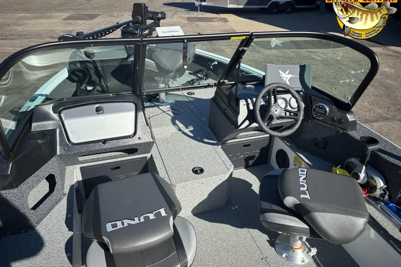 Slide: The Image of 2026 Lund 1800 Explorer Sport boat interior with steering wheel and seating. - 5
