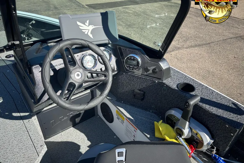 Slide: The Image of 2026 Lund 1800 Explorer Sport boat interior with steering wheel and dashboard controls. - 6