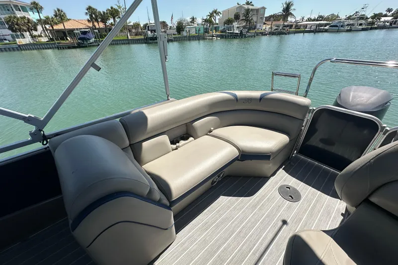 Slide: The Image of 2015 Berkshire 250E Premium pontoon boat interior with comfortable seating by the water. - 22