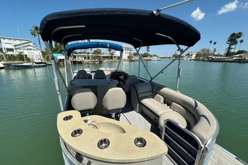 Slide: The Image of 2015 Berkshire 250E Premium pontoon boat with canopy on a sunny day. - 24
